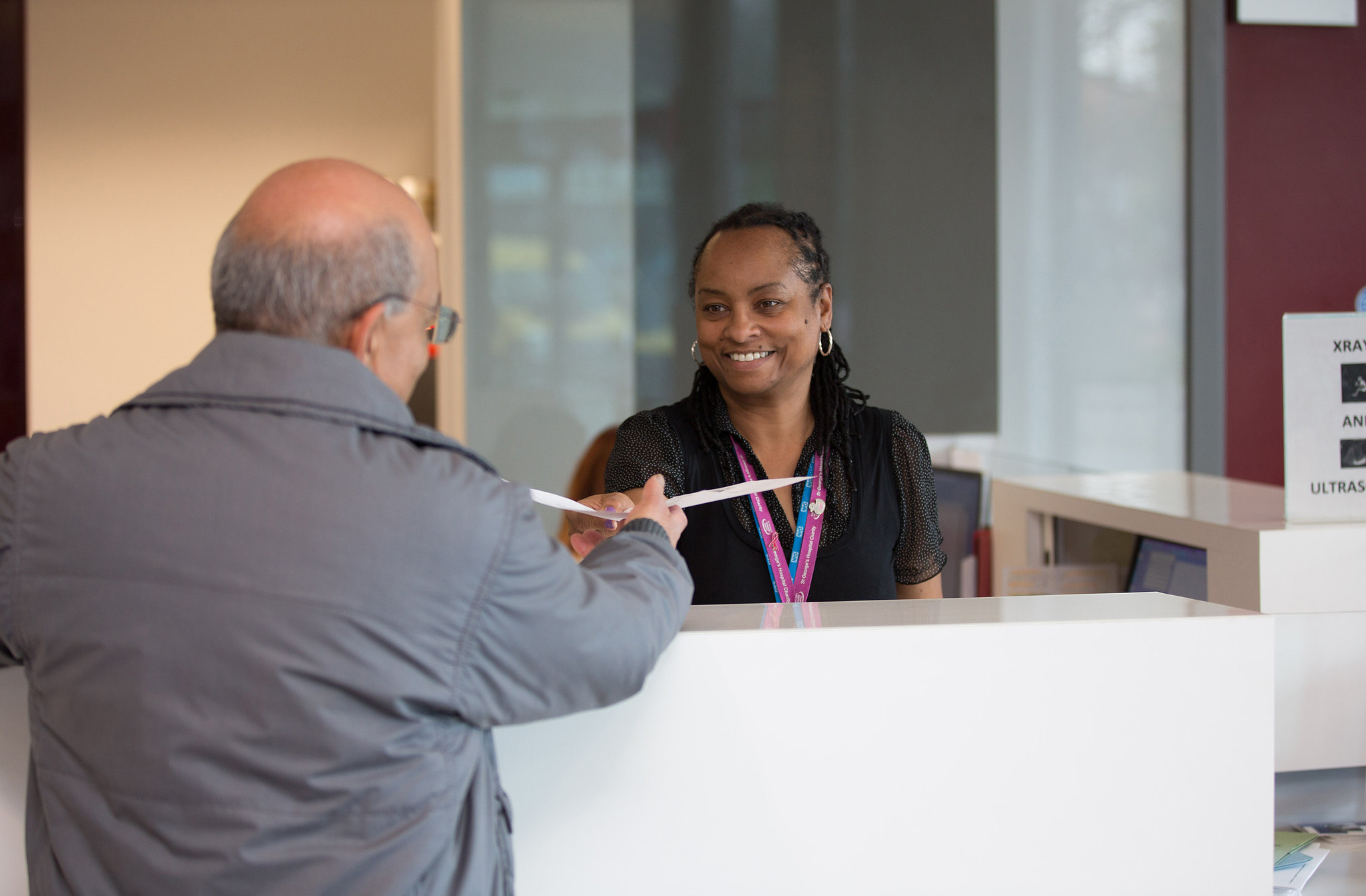 Man talking to receptionist