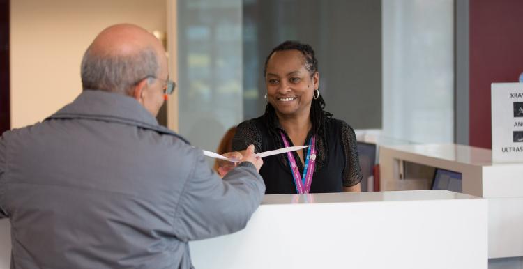 Man talking to receptionist