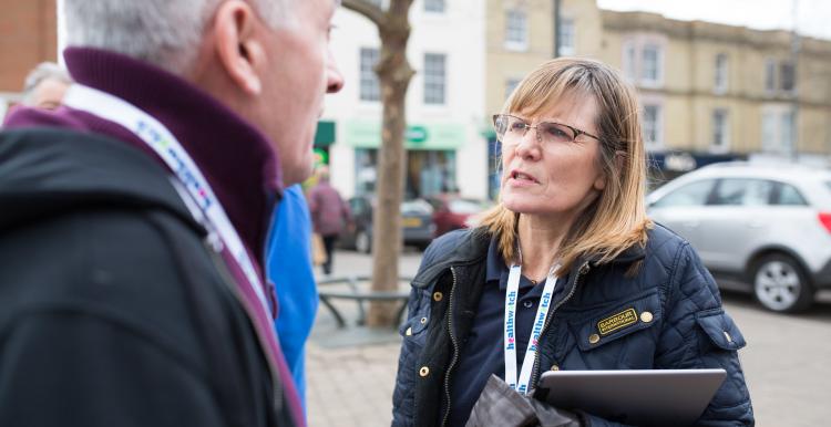 Healthwatch staff member talking to a member of the public about their experience