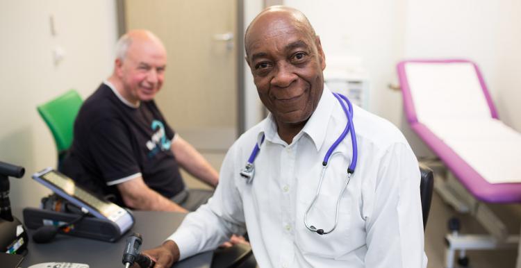 Male doctor speaking to a patient