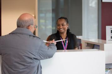 Man talking to receptionist