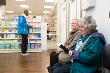 Image of people waiting at Pharmacy