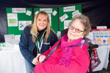 Healthwatch volunteer speaking to an elderly lady at an event