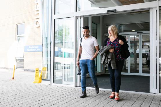 Two people leaving the hospital together