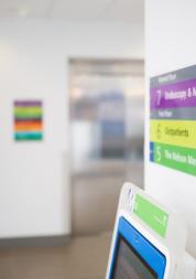 Woman waiting for a lift in a hospital setting