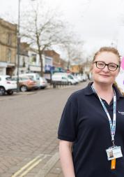 Healthwatch Staff member infront of some branded  promotional material at a Healthwatch event