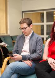 Two people sitting in a waiting room